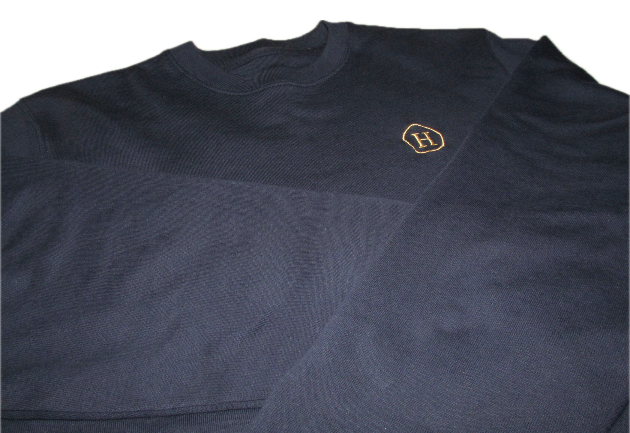 Navy blue sweater with a gold logo on a white background