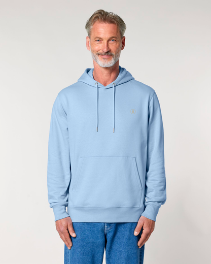 Man wearing a light blue hoodie with a small logo on a plain background