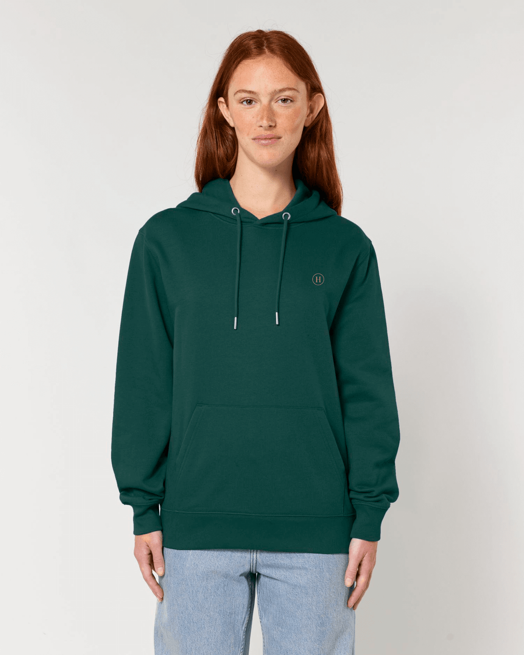 Person wearing a green hoodie with a logo on a plain background