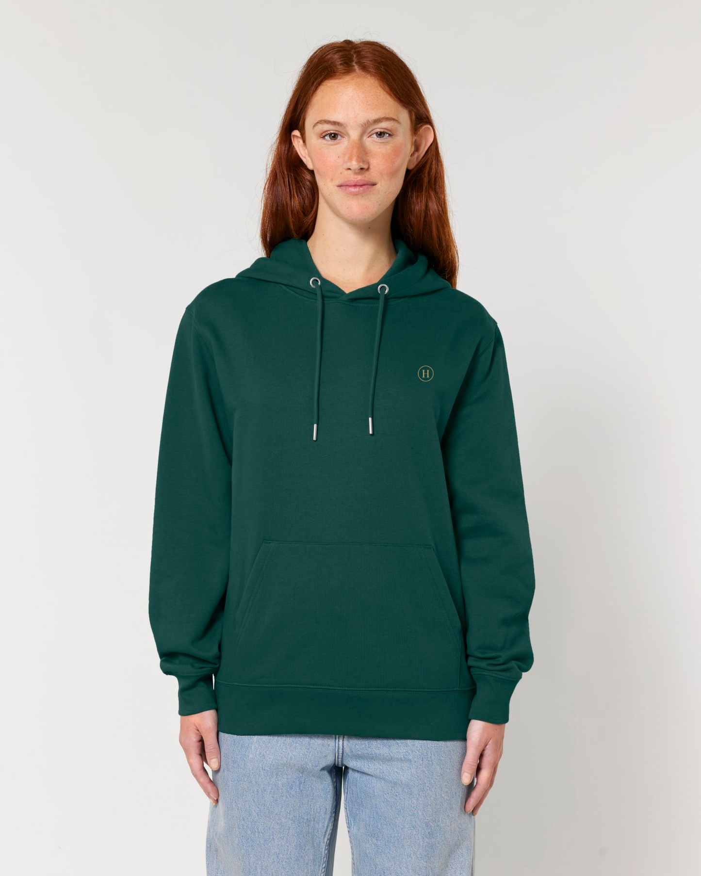 Person wearing a green hoodie with a logo on a plain background
