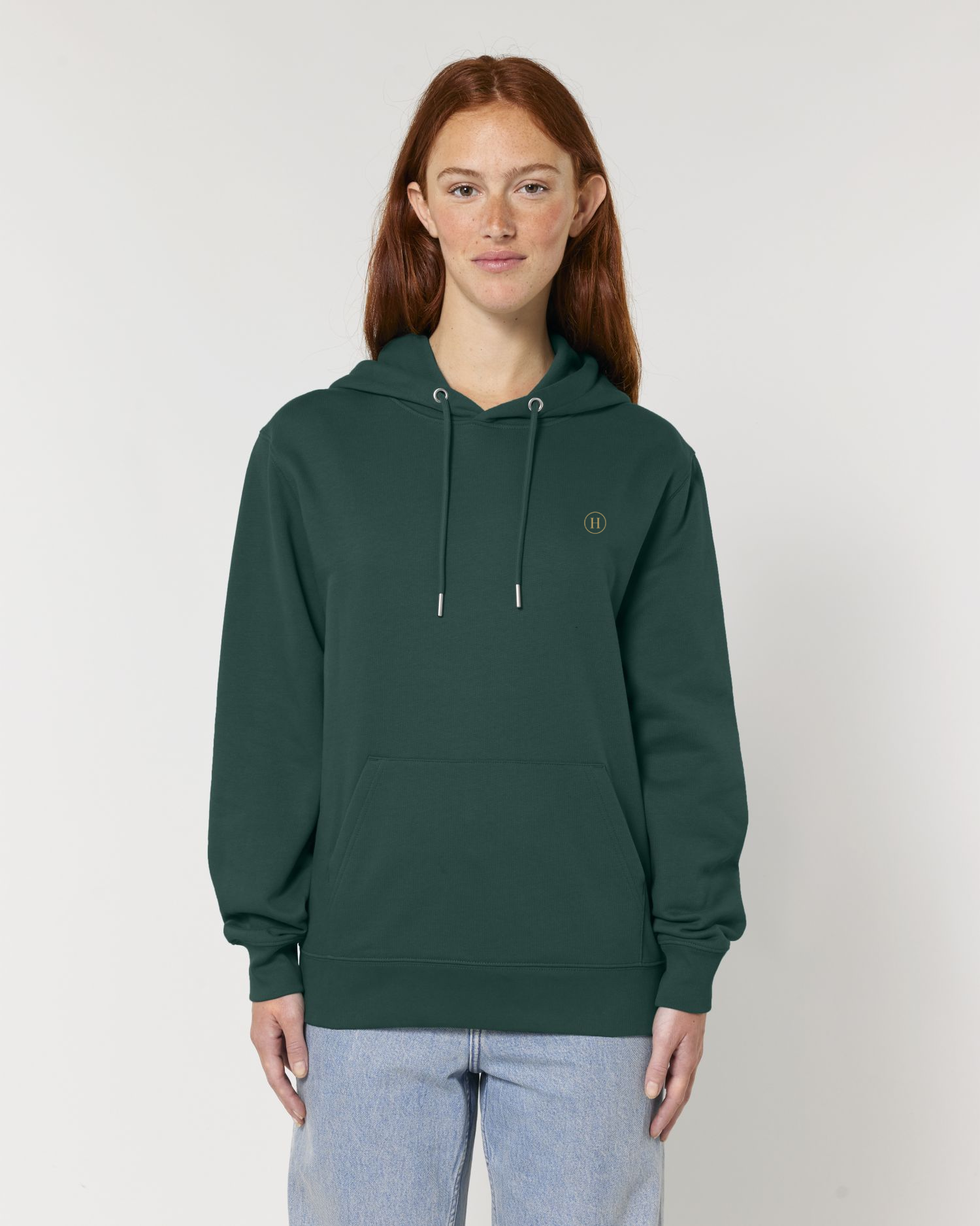 Person wearing a green hoodie with a logo on a plain background