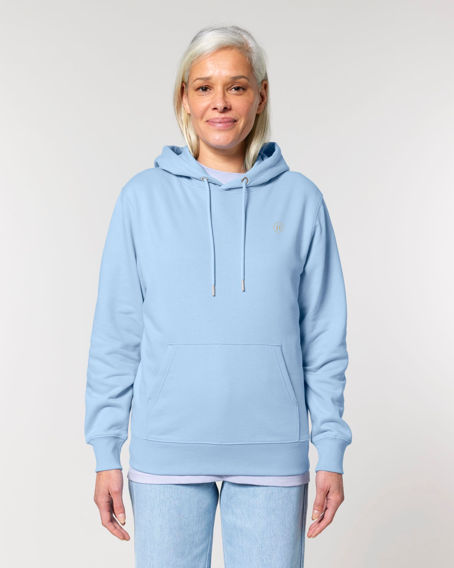 Person wearing a light blue hoodie and pants on a plain background