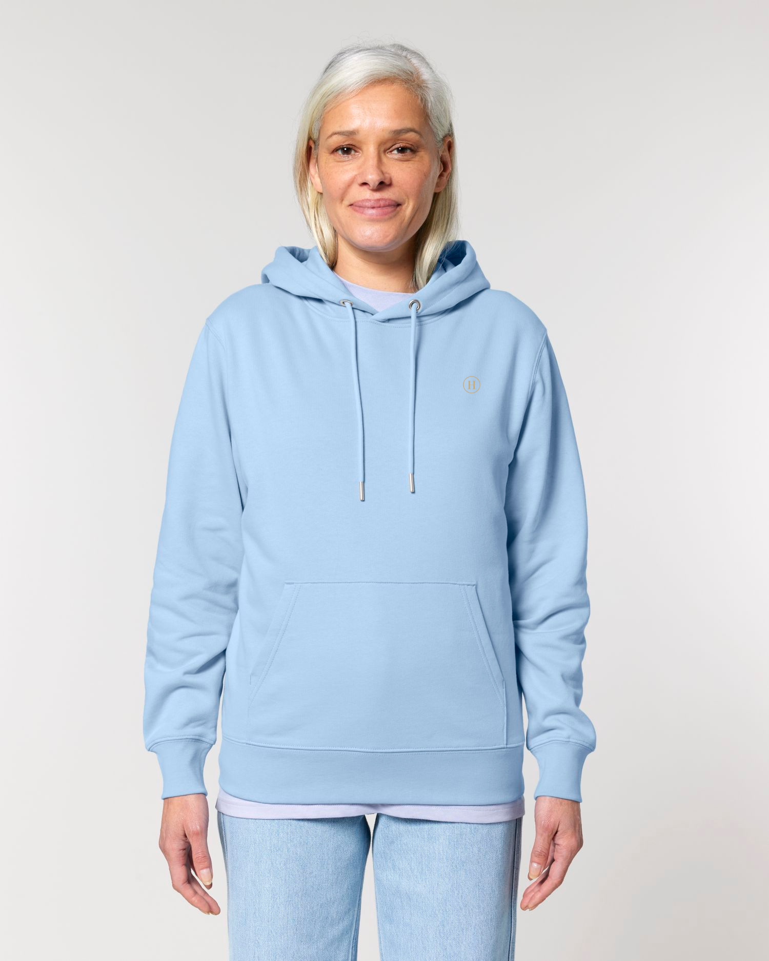 Person wearing a light blue hoodie and pants on a plain background