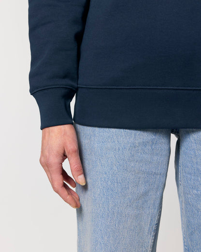 Navy blue sweatshirt and light blue jeans on a plain background